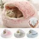 Round plush pet bed with removable cover, ideal for cats and small dogs, offering warmth and comfort.