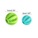 Dog toy treat balls in green and blue with textured grooves for chewing and treat dispensing.