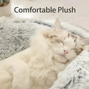 Round plush pet bed for cats and small dogs, cozy and warm winter sleeping nest with removable cover.